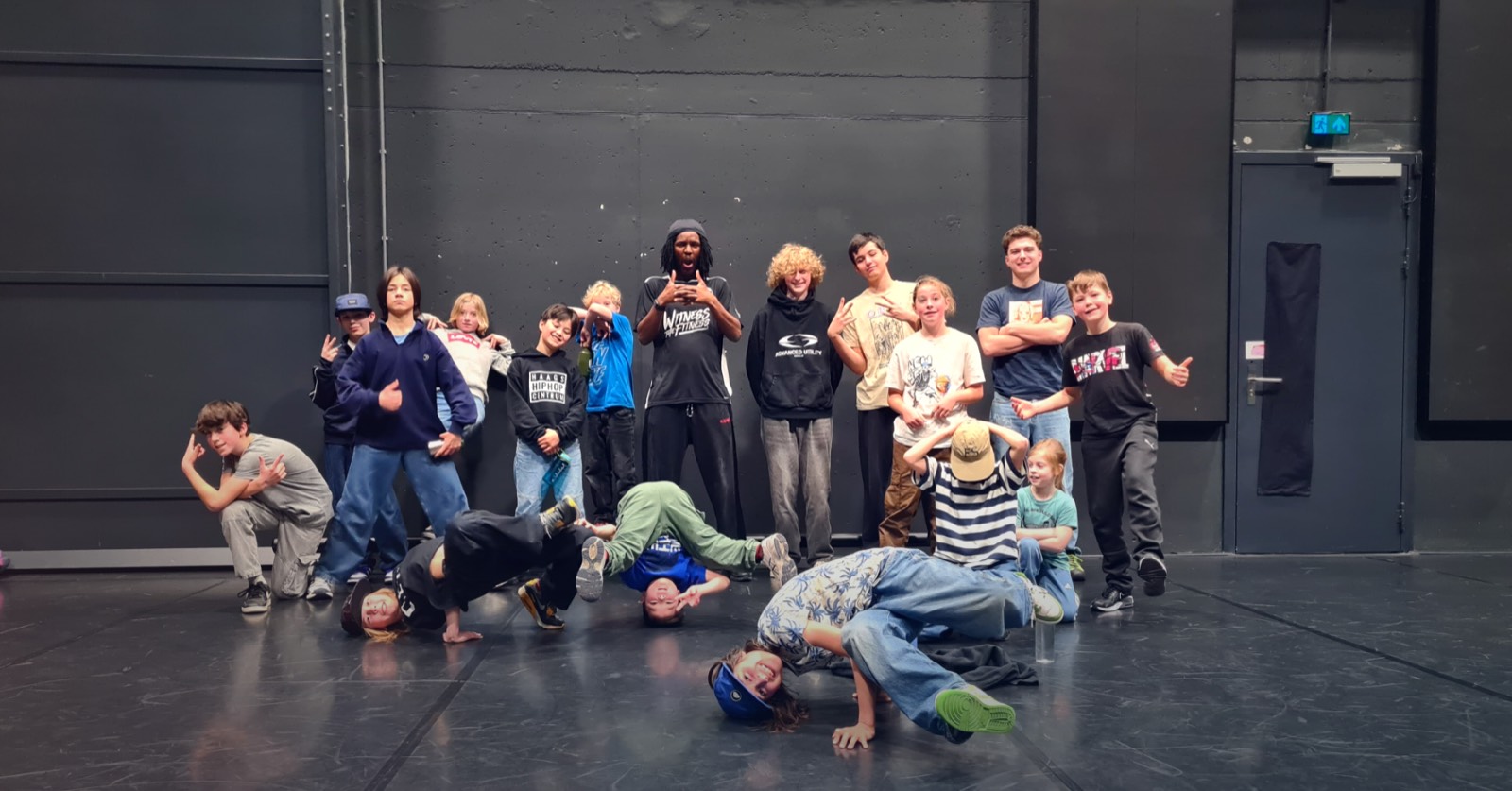 Een groep kinderen na een hiphop- en breakdanceworkshop